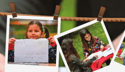 Children's drawings and photographs pegged on a line