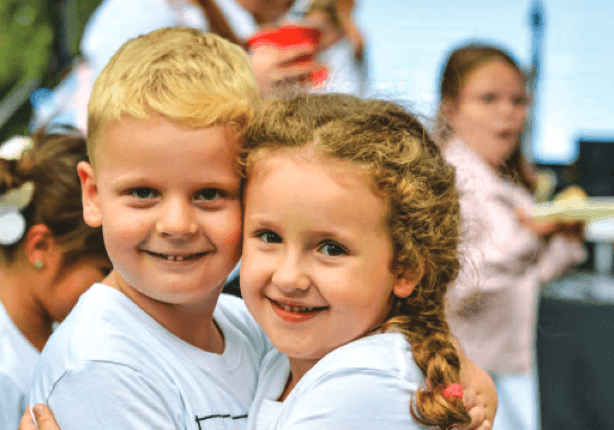 Two smiling children at an Alkaloid family event