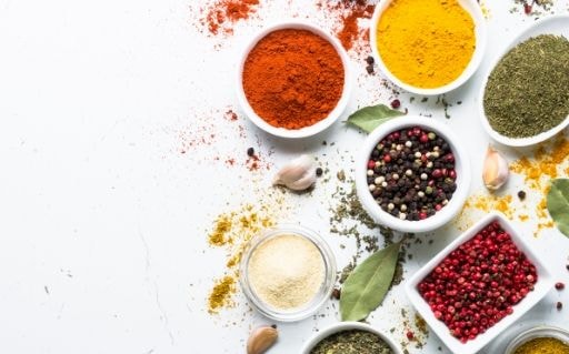 Assorted ground spices in small bowls seen from above