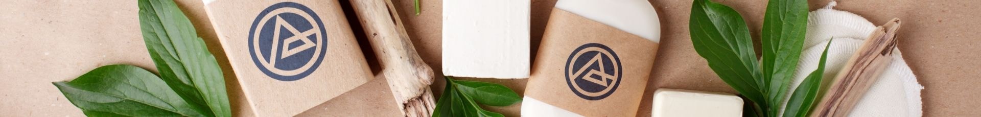 Soap bars in branded kraft paper packaging with green leaves