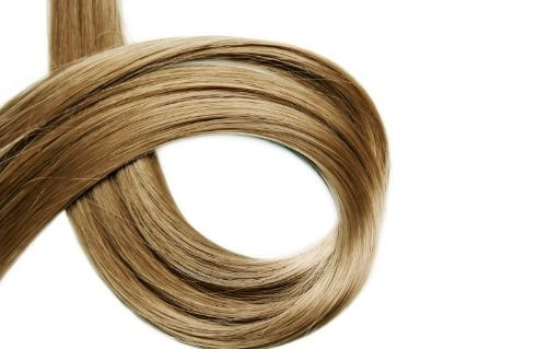 Coil of smooth blonde hair on a white background