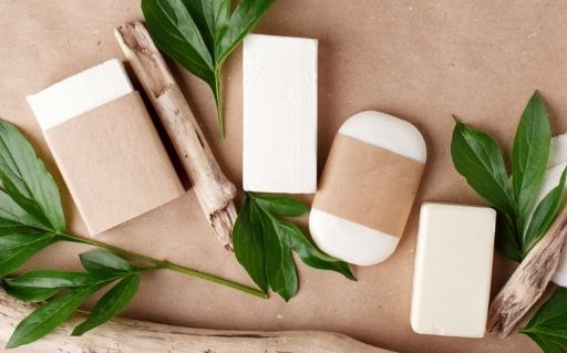 Bars of soap and kraft paper packaging with green leaves