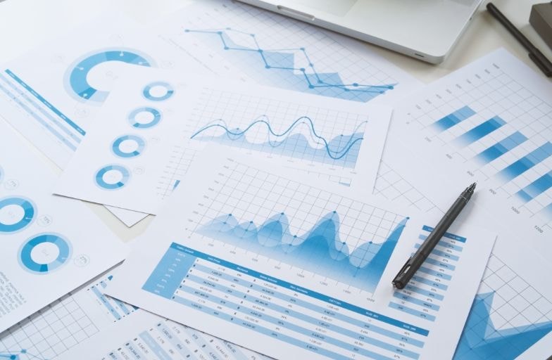 Printed financial reports with charts and graphs on a desk